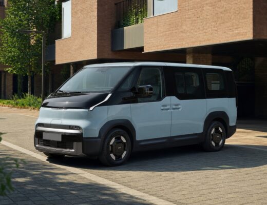 Kia PV5 electric passenger van in a contemporary urban setting