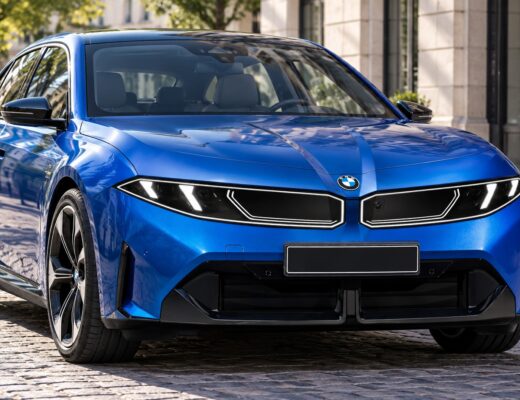 Blue BMW i3 electric sedan parked on a cobblestone city street.